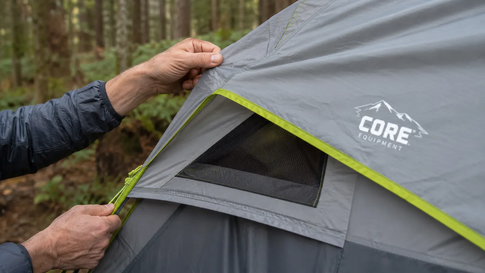 Close-up of CORE tent rainfly showing the gap above the mesh vent panel near the main door